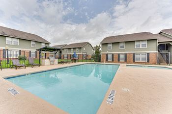 Swimming pool with sundeck and pergola seating area